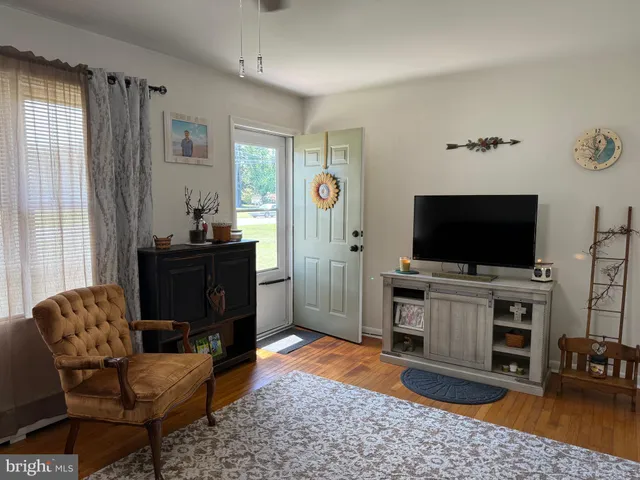 a view of a livingroom with furniture and a flat screen tv