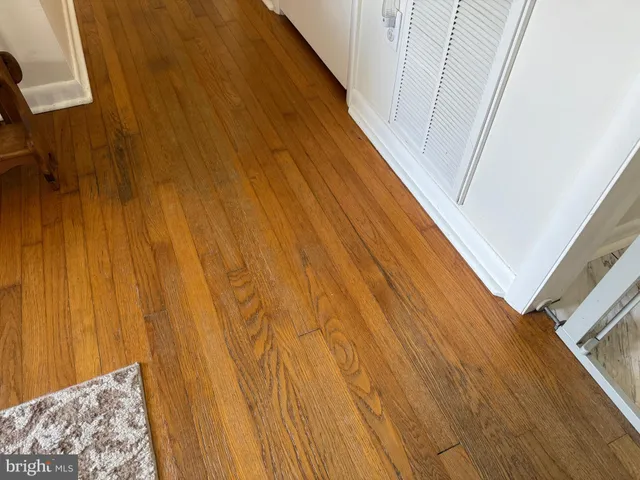 a kitchen with refrigerator cabinets and wooden floor