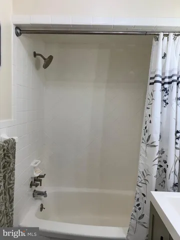 a bathroom with a toilet and a mirror