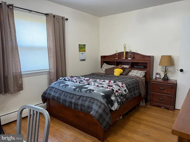 a bedroom with a bed and a television