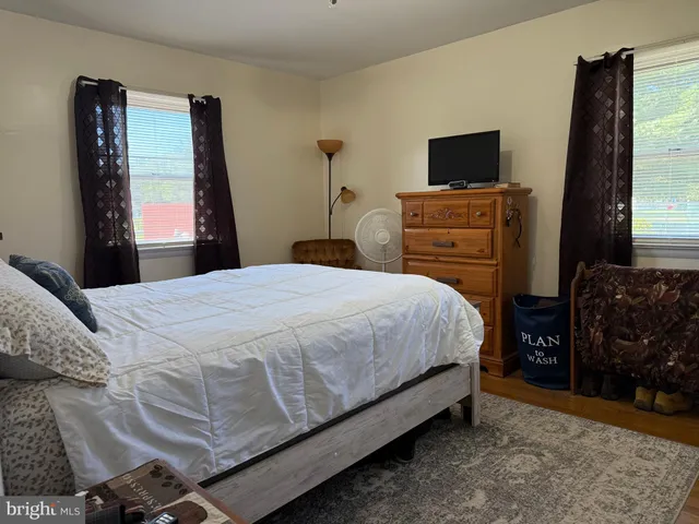 a bedroom with a bed and a painting on the wall