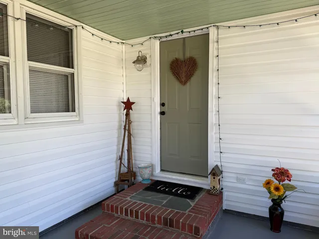 a view of a chairs and table in patio with a backyard
