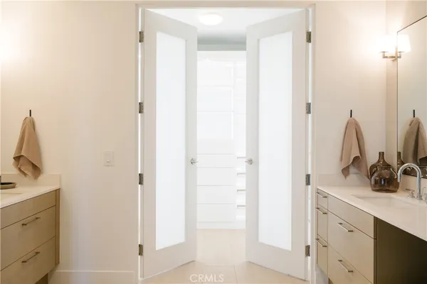 a bathroom with a double vanity sink a and a mirror