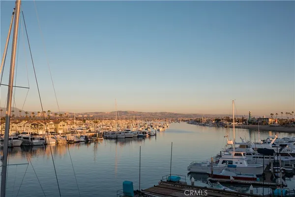 a view of a lake with boats and trees in the background