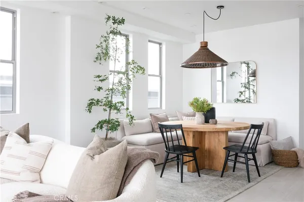 a dining room with furniture a chandelier and window