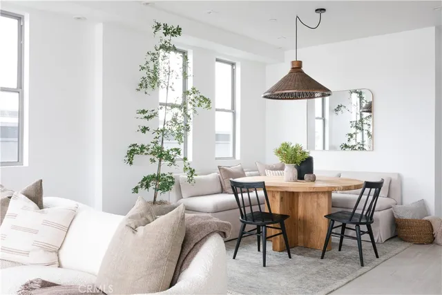 a dining room with furniture a chandelier and window