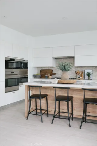 a kitchen with a table and chairs in it