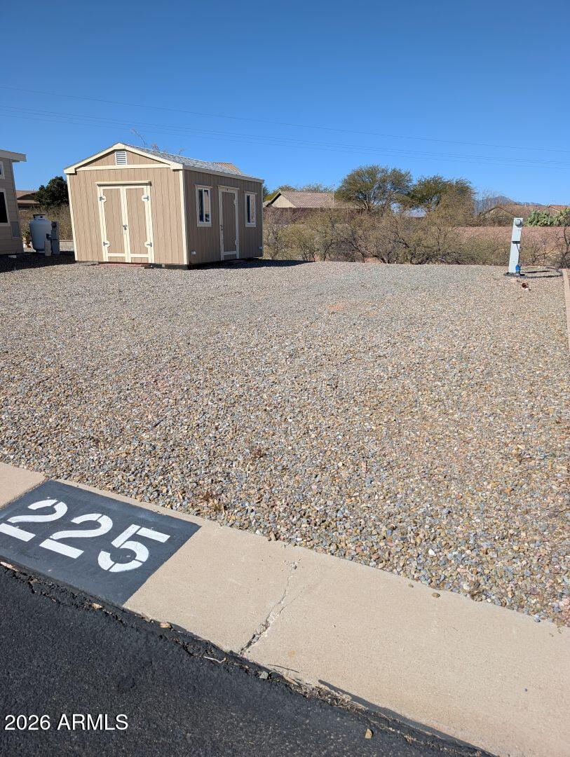 1030 Barrel Cactus Ridge, Unit 225 Benson, AZ 85602 - Photo 2 of 15 a view of a dry yard with mountain