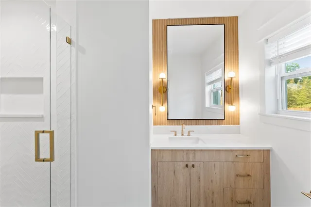 a bathroom with 2 sink and a mirror