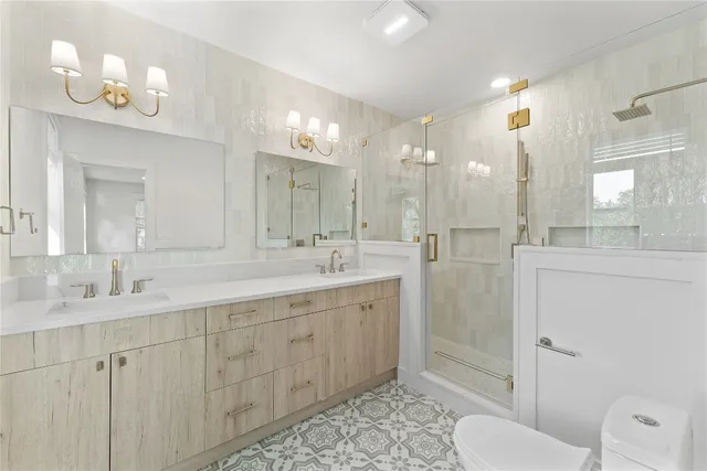a spacious bathroom with a double vanity sink mirror and toilet