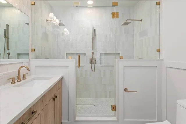 a bathroom with a shower sink and mirror