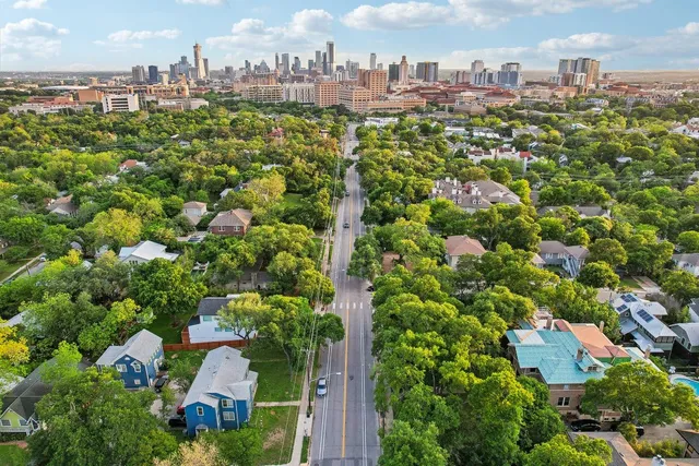 an aerial view of residential houses with city view