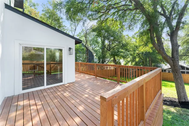 a view of balcony with wooden floor and fence