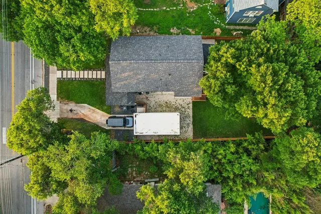 an aerial view of a house with garden space and street view