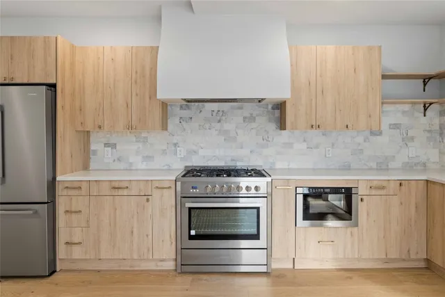 a kitchen with granite countertop white cabinets and white stainless steel appliances