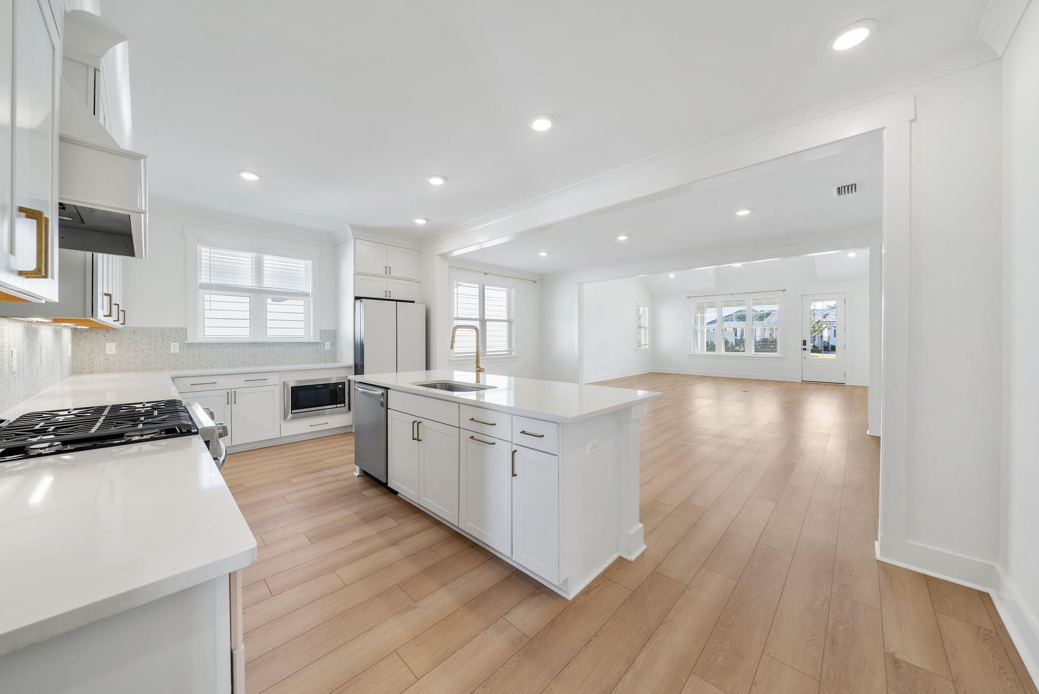1917 Rushes Avenue Panama City, FL 32405 - Photo 13 of 66 a kitchen with white cabinets and wooden floor