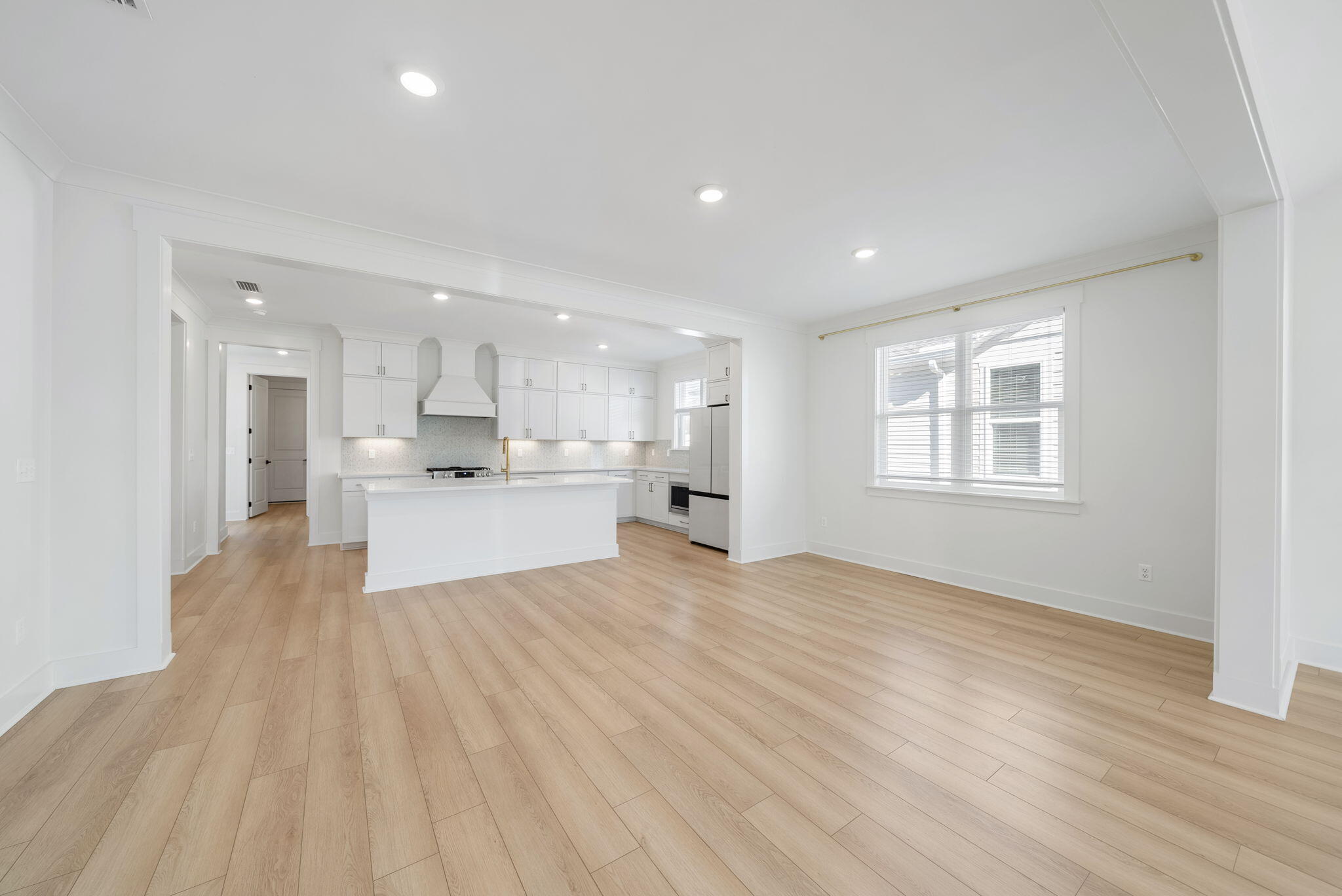 1917 Rushes Avenue Panama City, FL 32405 - Photo 6 of 66 a view of a kitchen with kitchen island a sink wooden floor and a refrigerator
