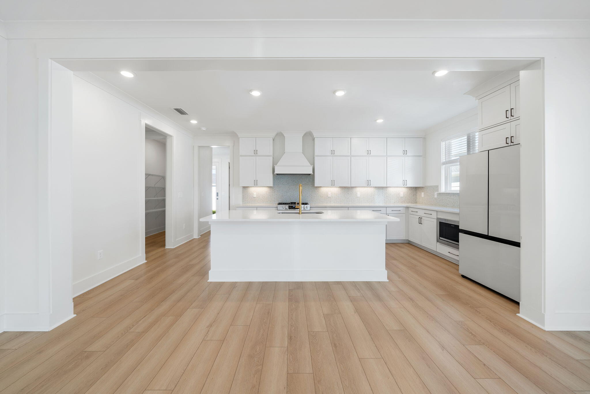 1917 Rushes Avenue Panama City, FL 32405 - Photo 9 of 66 a large kitchen with stainless steel appliances kitchen island a large counter top and a stove top oven