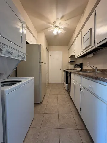 a kitchen with a cabinets and white stainless steel appliances