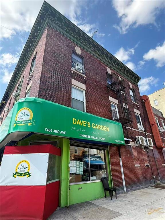 7404 3rd Avenue Brooklyn, NY 11209 - Photo 2 of 9 a sign that is on the side of a building