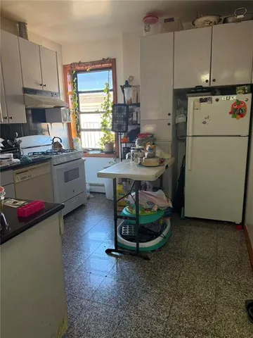 a kitchen with a refrigerator and a stove