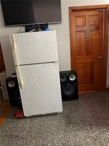a white refrigerator freezer sitting in a kitchen