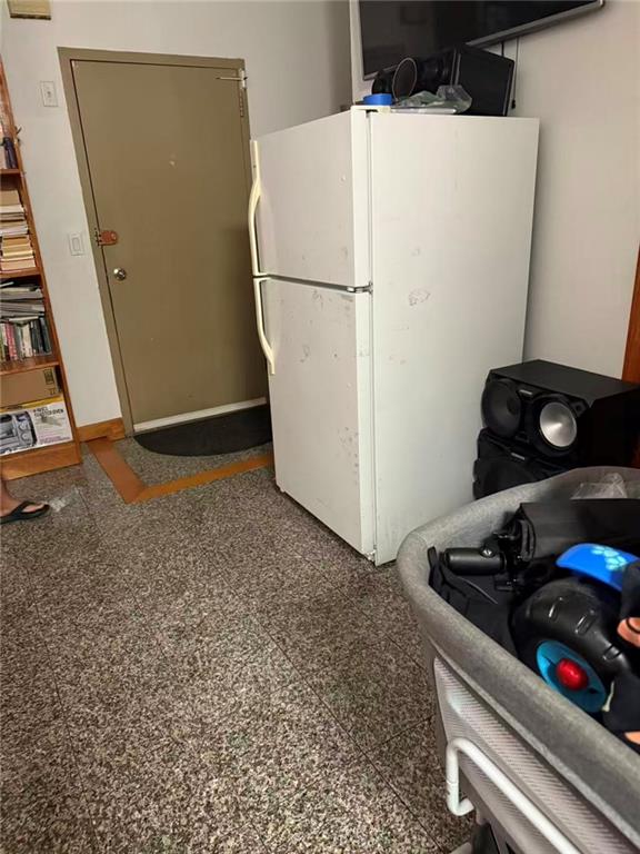 7404 3rd Avenue Brooklyn, NY 11209 - Photo 8 of 9 a white refrigerator freezer sitting next to a wooden wall