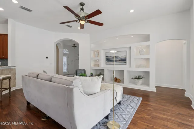 a view of a dining room with furniture and a chandelier