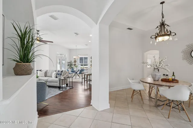 a view of a dining room with furniture and chandelier