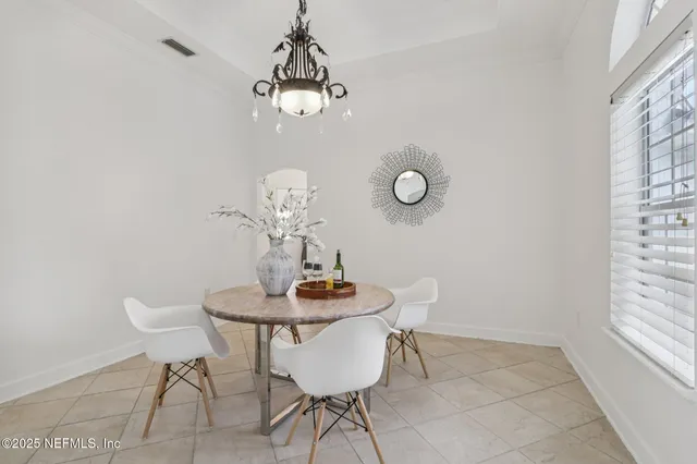 a living room with kitchen island furniture and a chandelier