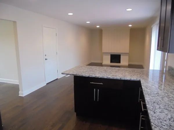 a view of kitchen island sink and fireplace