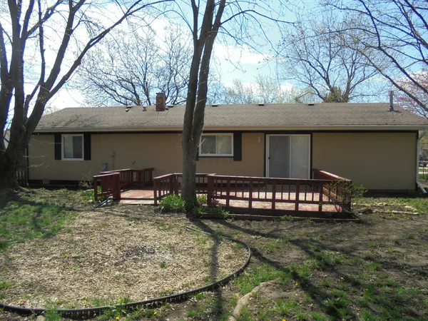 a backyard of a house with table and chairs
