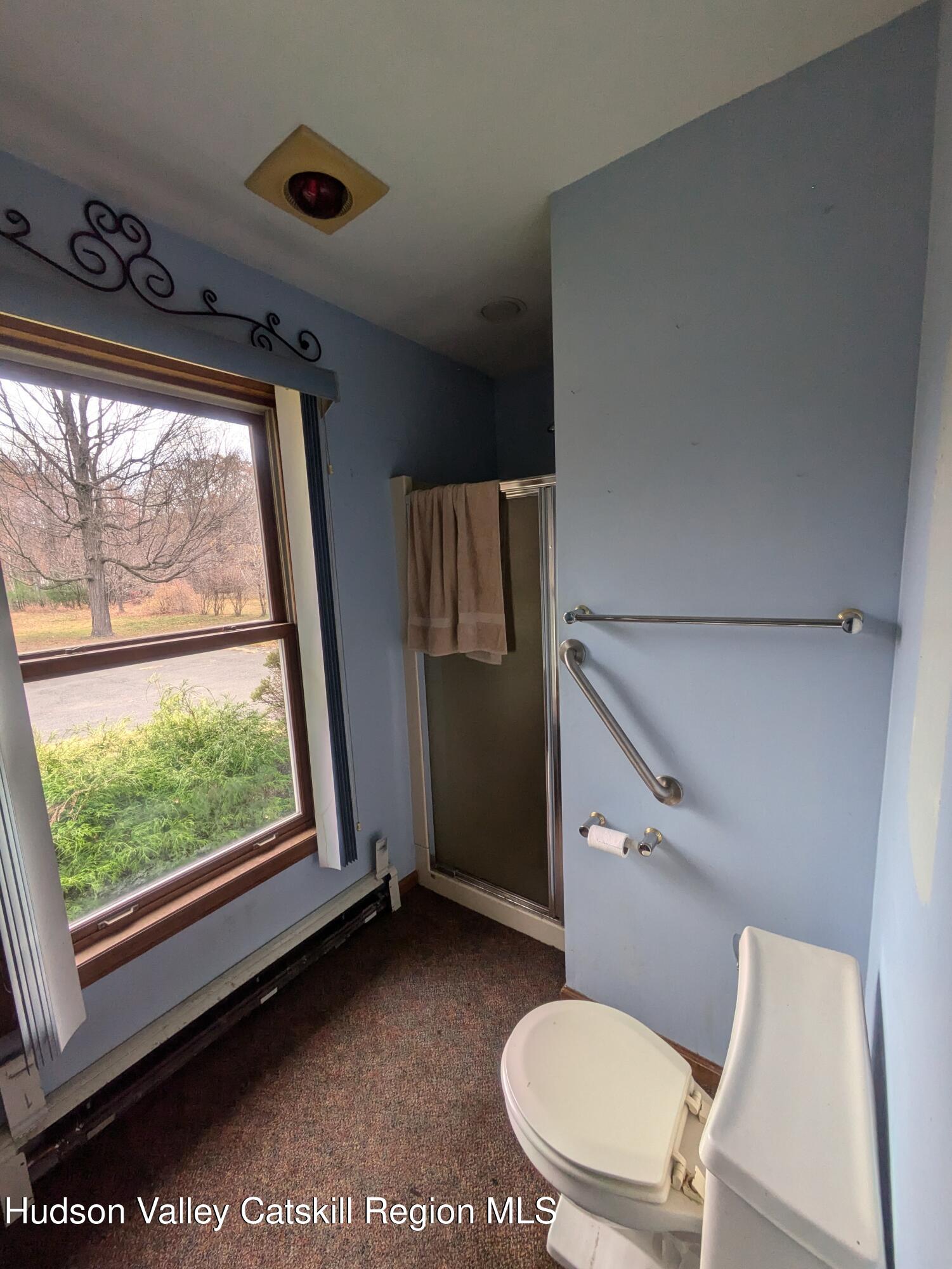 15 Valk Road Saugerties, NY 12477 - Photo 26 of 35 a bathroom with a toilet mirror vanity and a shower