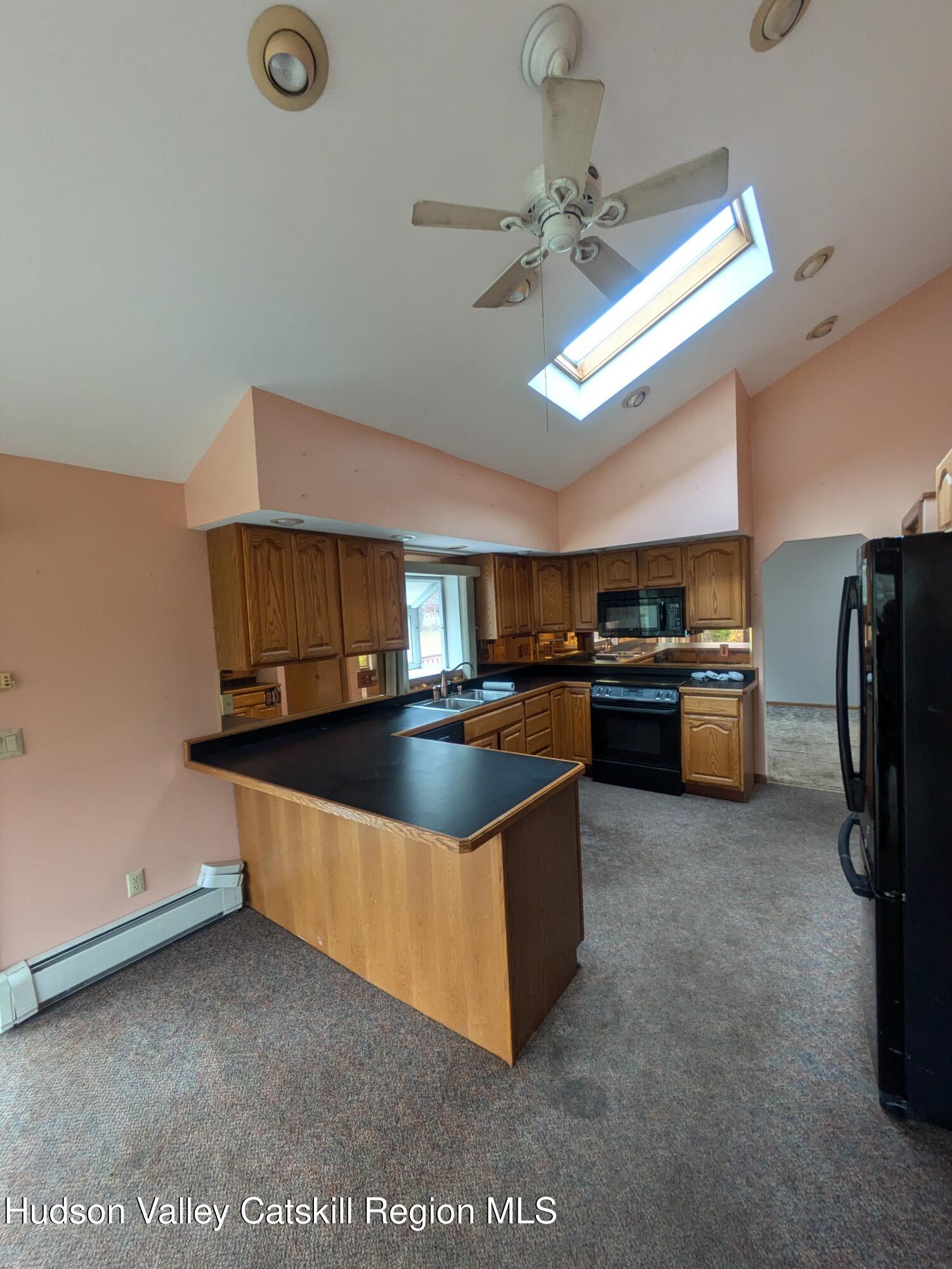 15 Valk Road Saugerties, NY 12477 - Photo 10 of 35 a kitchen with stainless steel appliances granite countertop a sink a stove and a refrigerator