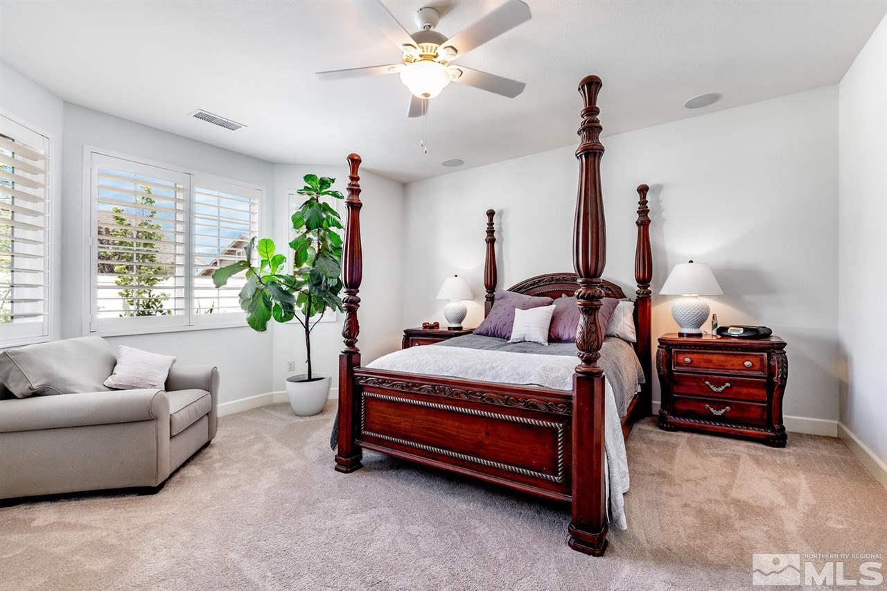 9645 Abigail Way Reno, NV 89521 - Photo 12 of 25 a bedroom with furniture and a chandelier