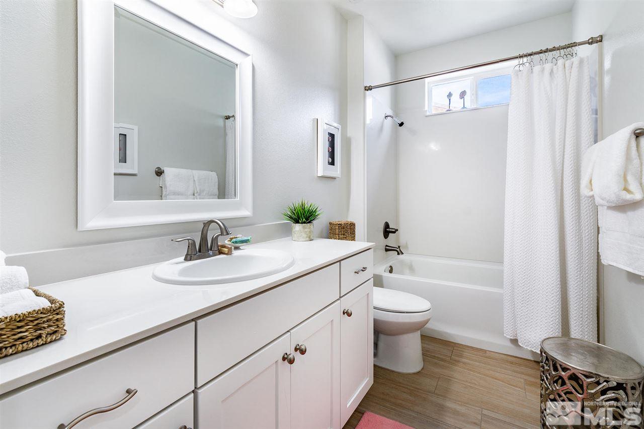 9645 Abigail Way Reno, NV 89521 - Photo 15 of 25 a bathroom with a sink a toilet and shower a mirror