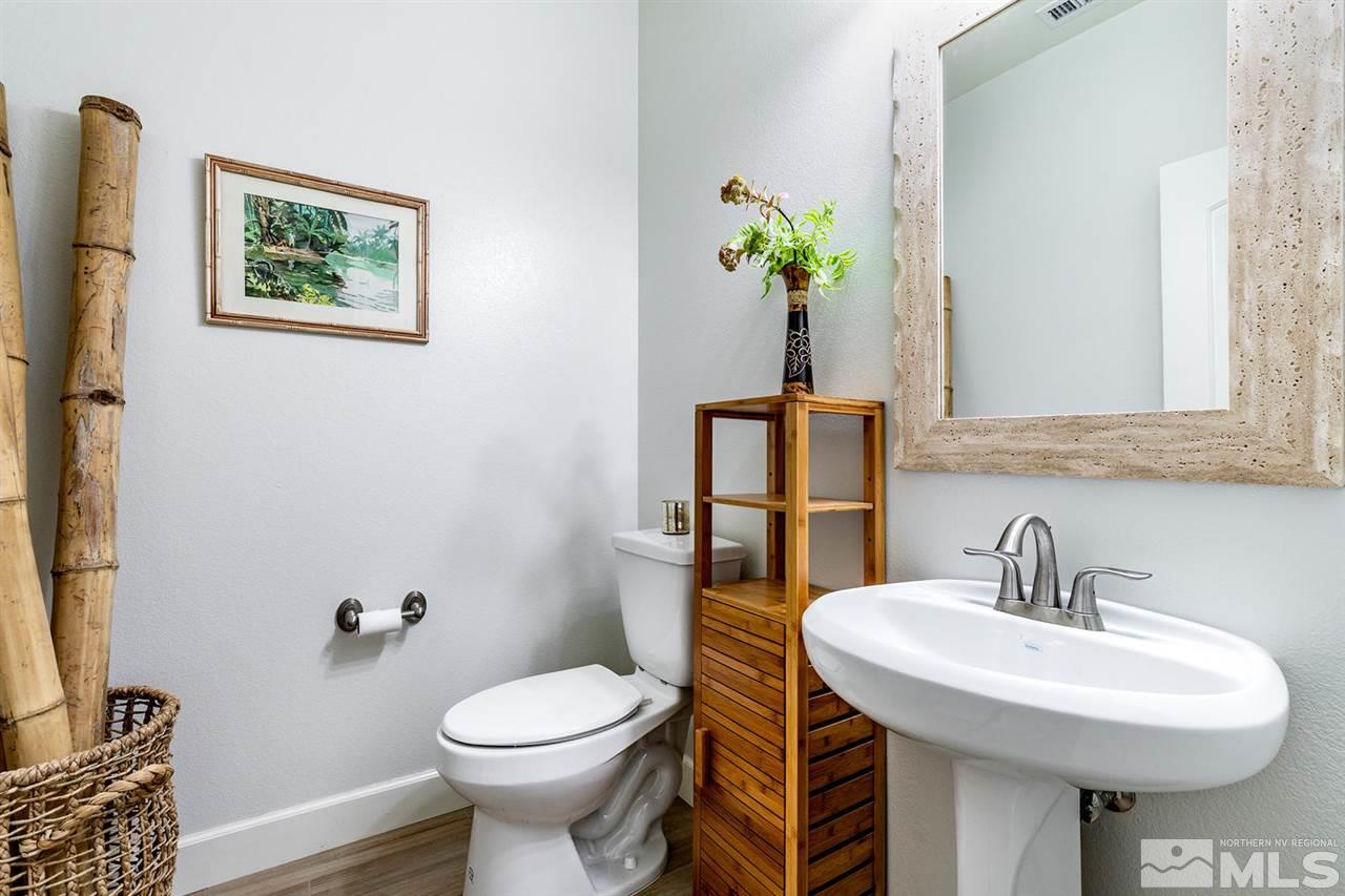 9645 Abigail Way Reno, NV 89521 - Photo 7 of 25 a bathroom with a sink toilet and a mirror
