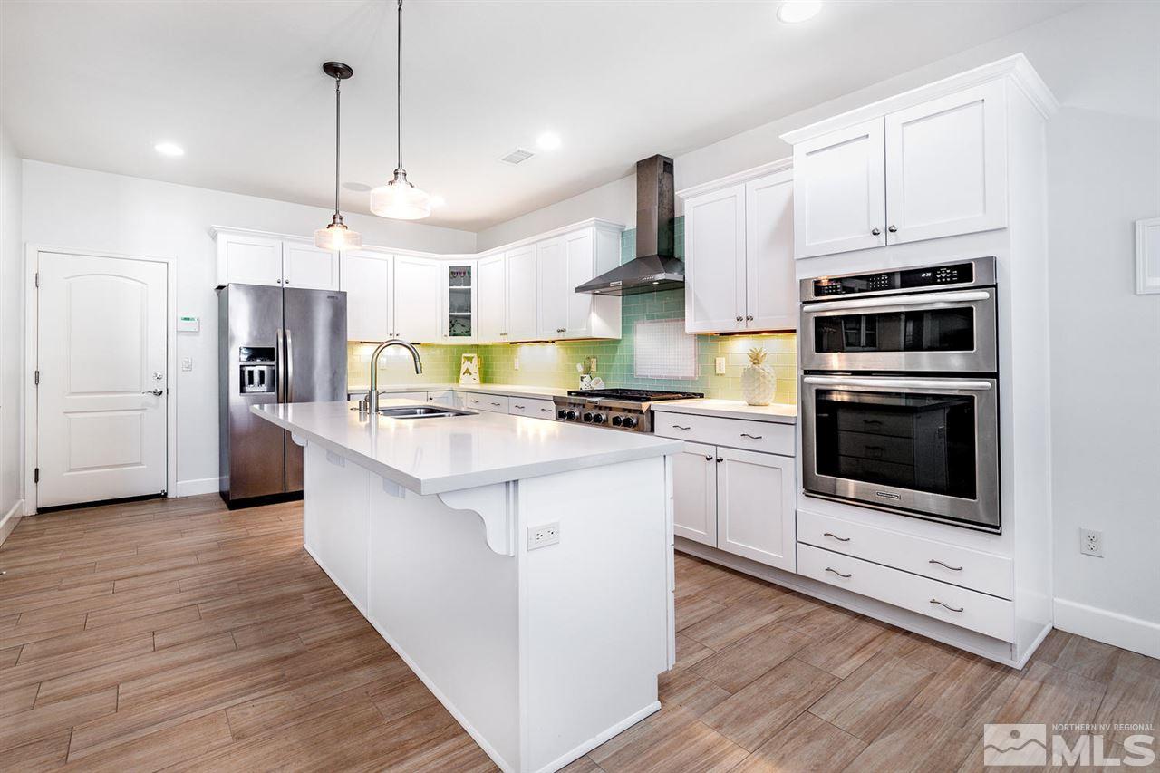 9645 Abigail Way Reno, NV 89521 - Photo 10 of 25 a kitchen with stainless steel appliances a stove a sink and a refrigerator