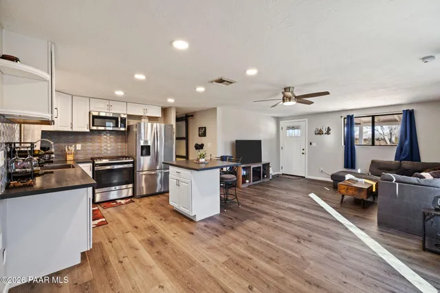 a kitchen with refrigerator a stove and a sink