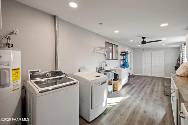 a spacious bedroom with a bed and a wooden floor