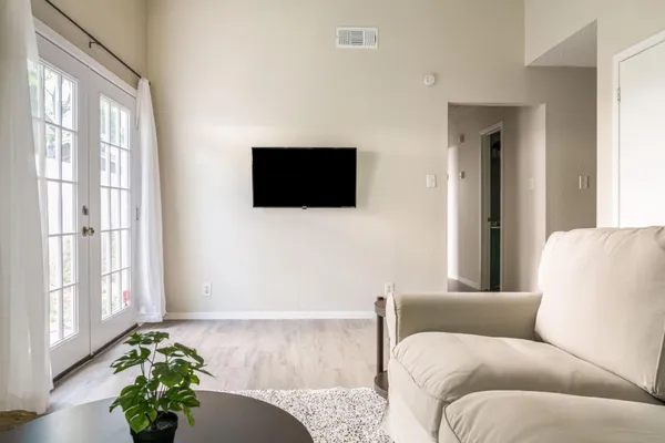 a living room with furniture and a flat screen tv