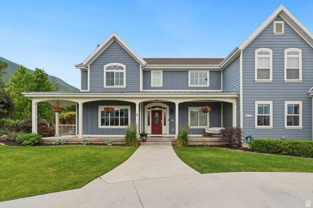672 Perry Hollow Drive Mapleton, UT 84664 - Photo 8 of 106 Two-story residence featuring blue siding, white trim, and a full-width front porch with white columns