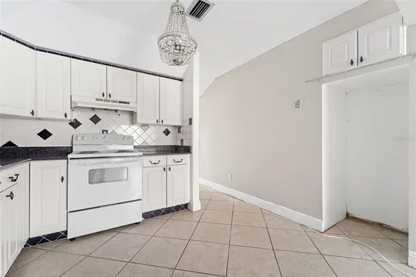 a kitchen with white cabinets and white appliances