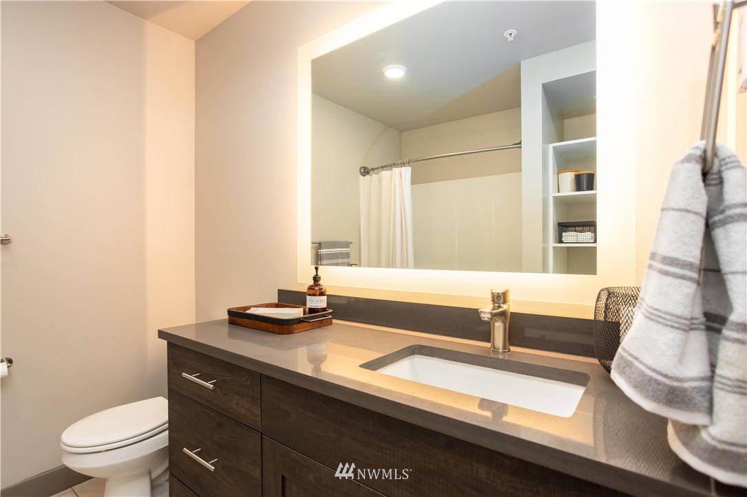 1882 Front Street, Unit 211 Lynden, WA 98264 - Photo 11 of 20 a bathroom with a granite countertop sink and a large mirror