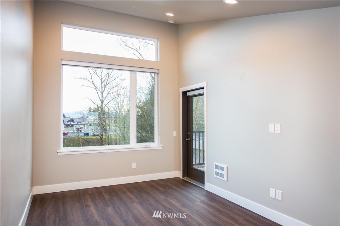1882 Front Street, Unit 211 Lynden, WA 98264 - Photo 13 of 20 an empty room with wooden floor and windows