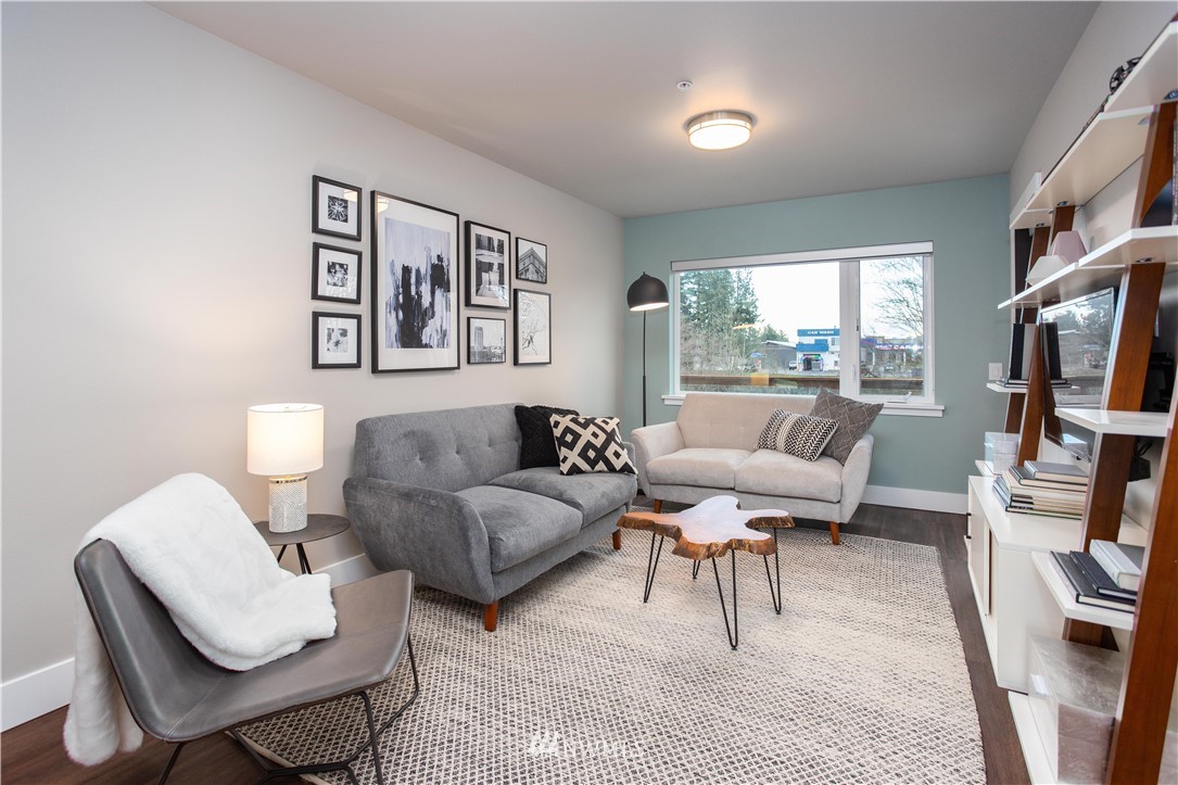 1882 Front Street, Unit 211 Lynden, WA 98264 - Photo 6 of 20 a living room with furniture and a book shelf