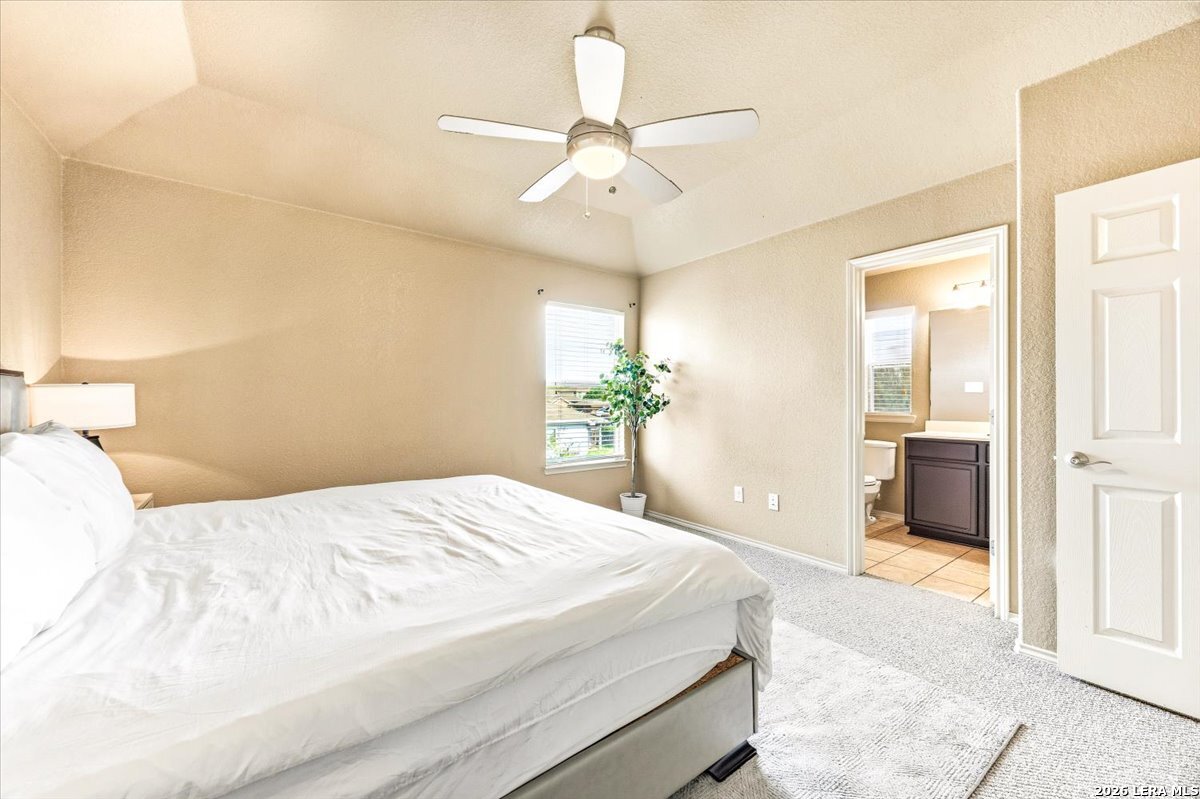 3831 Bacall Way Converse, TX 78109 - Photo 20 of 33 a bedroom with a large bed and chandelier