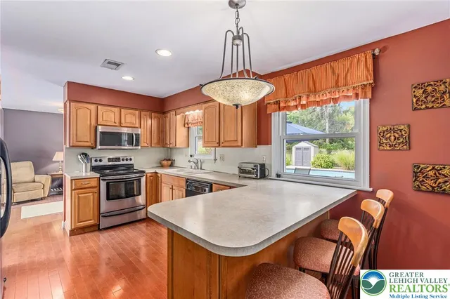a kitchen with stainless steel appliances granite countertop a stove a sink and a refrigerator