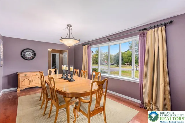 a dining room with furniture and window