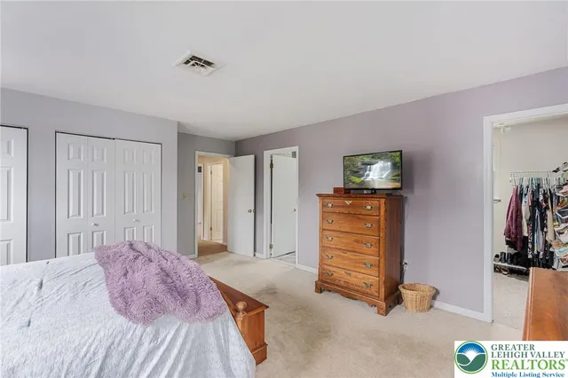 a bedroom with a bed and a view of bedroom